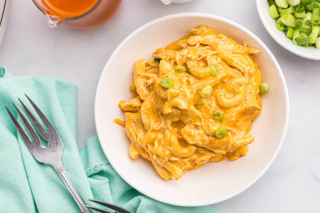 Overhead shot of buffalo chicken mac and cheese garnished with green onions.