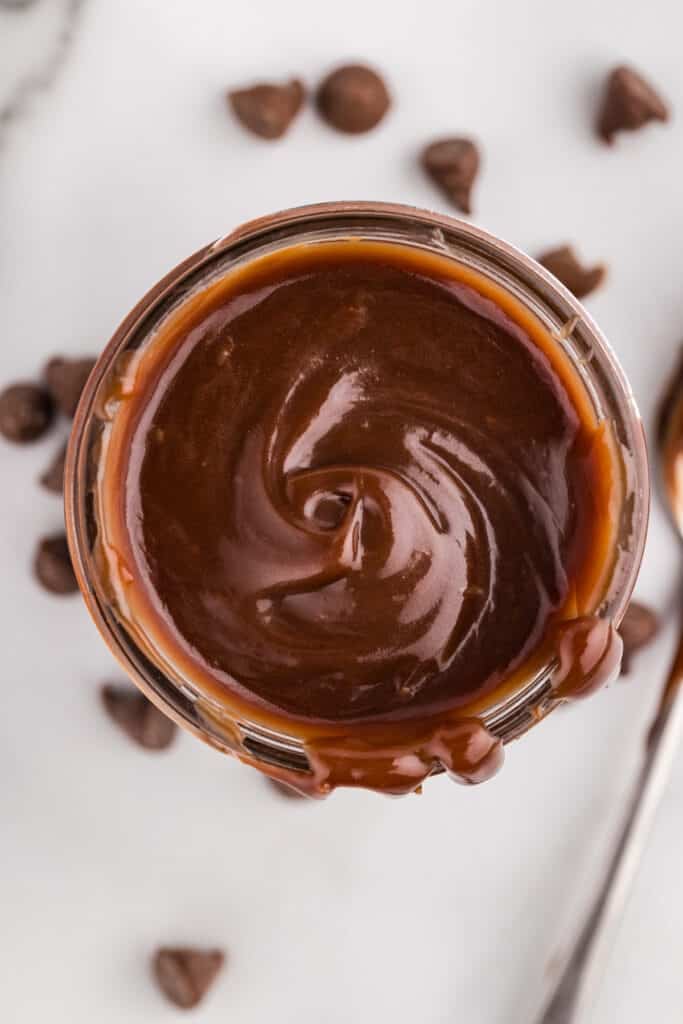 a jar filled with swirled hot fudge.