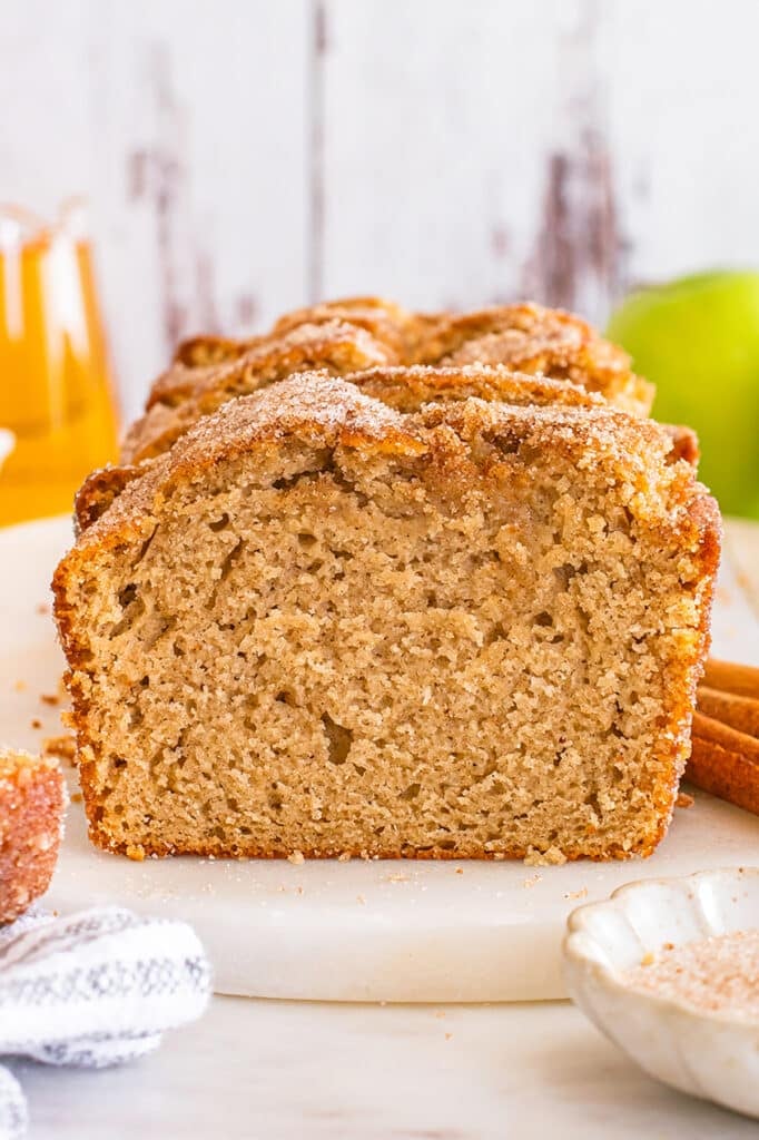 Slice of apple cider donut bread showing soft, tender texture inside.