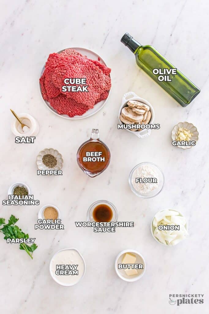labeled ingredients for slow cooker cube steak arranged on a white surface.