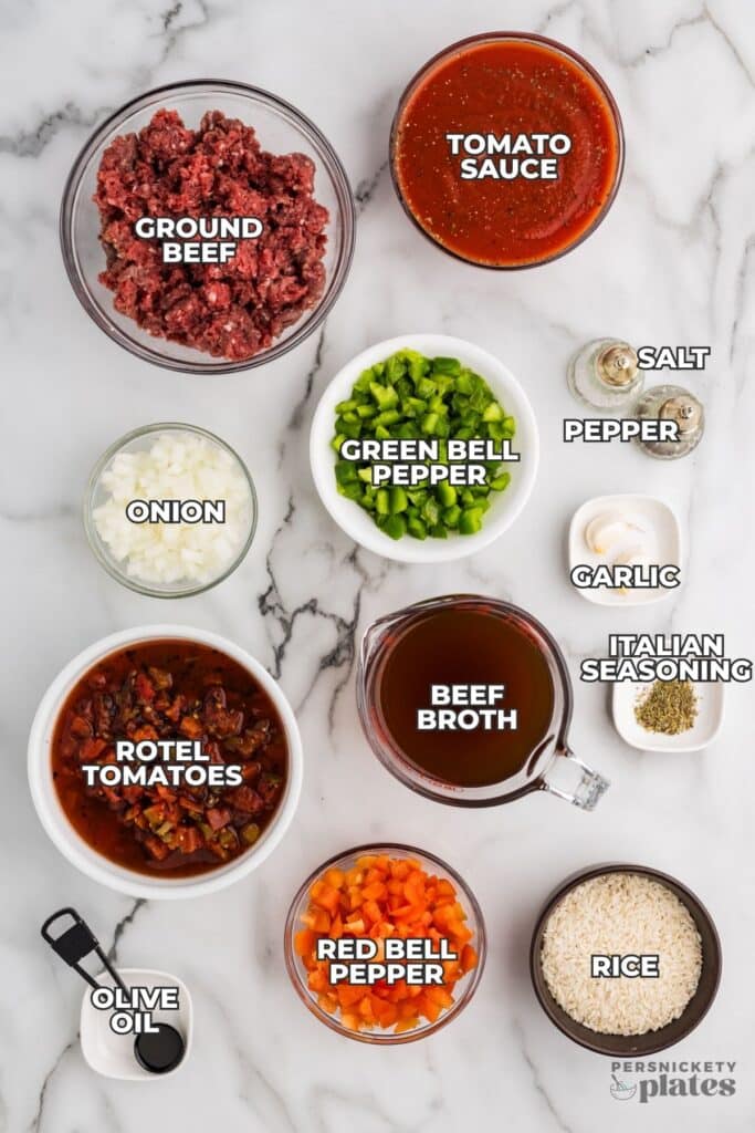 Ingredients for stuffed pepper soup arranged on a marble surface.