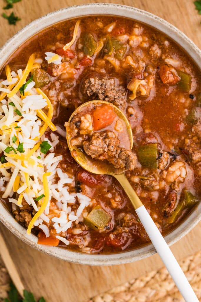 A bowl of stuffed pepper soup with a spoonful lifted.