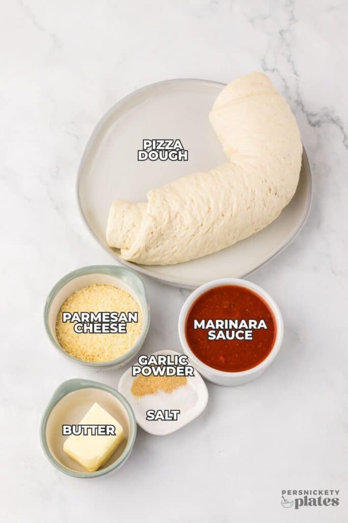 Ingredients for breadsticks labeled on a white surface.