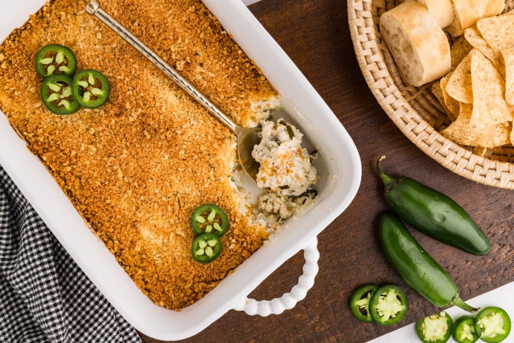 Baked jalapeño popper dip topped with breadcrumbs and sliced jalapeños.
