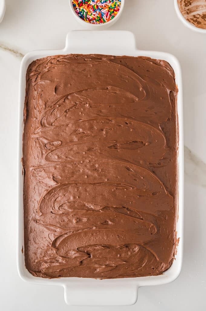 yellow sheet cake covered in smooth chocolate frosting.